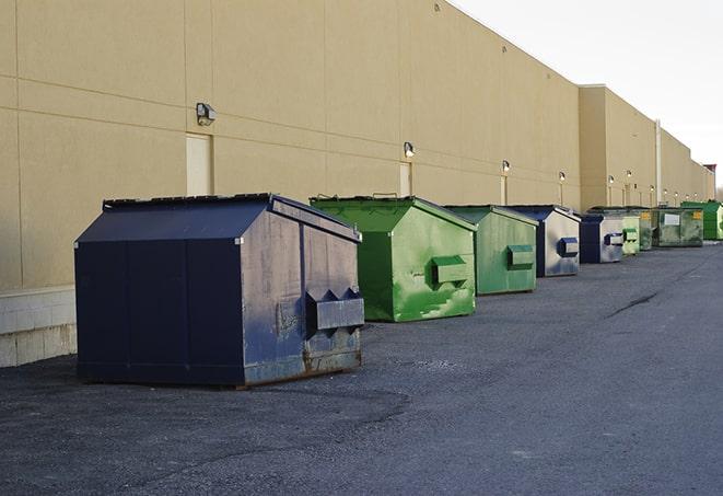 a collection of bright and vibrant dumpsters in a construction zone in Commerce